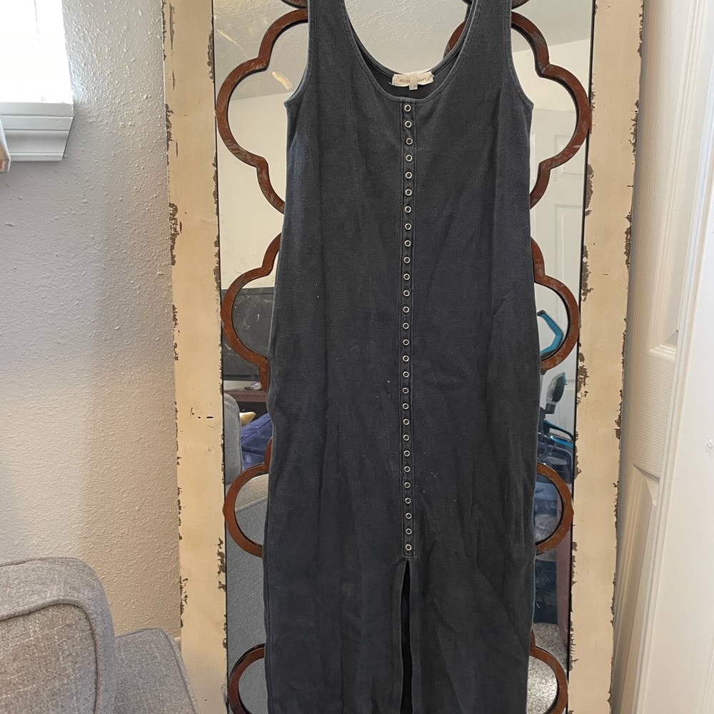 Long fitted dress with slit in the middle. Goes slightly pass the knees.